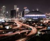 A nighttime time-lapse pan across the city skyline including the New Orleans Superdome.