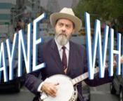 Artist Wayne White playing the banjo while strapped to a flatbed truck driving through New York City; what else is there to say? Here&#39;s a short music video offering a behind the scenes peek into Wayne’s recent show,