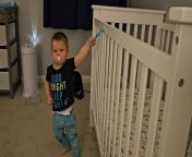 This kid was trying to pull off a suction cup toy, which his father had put on the crib. After several tries, he succeeded but pulled so hard that he toppled over when it came off. His smile of success reflected his joy. However, when he attempted to stick the toy back on the crib, he failed.