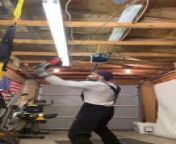 This man was practicing his boxing skills in his garage when he accidentally broke the ceiling light. As he punched the bag, it hit the tube light in the ceiling, causing it to break. As the punching bag swung around, it also pulled down the man&#39;s band saw, creating a mess in the garage.