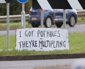 A mystery artist has been mocking a council by erecting signs around a town slamming the state of its pothole-ridden roads.&#60;br/&#62;&#60;br/&#62;The anonymous campaigner, known as the Daventry Banksie, has left motorist baffled after putting up 26 hand-painted signs around Daventry, Northants.&#60;br/&#62;&#60;br/&#62;Despite them being repeatedly removed, she is vowing to continue making more &#60;br/&#62;in a bid to shame West Northamptonshire Council into repairing the potholes. &#60;br/&#62;&#60;br/&#62;The comical signs dub Daventry &#92;