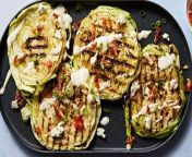 These grilled cabbage steaks—covered in bacon, ranch dressing, blue cheese, and scallions—are the ultimate summer BBQ main.